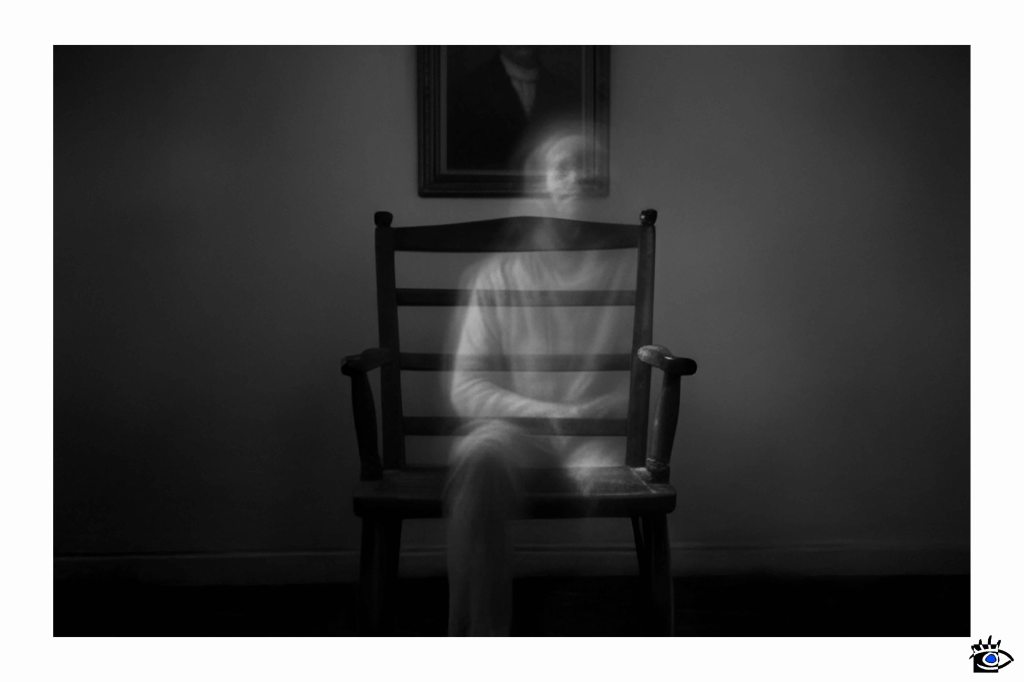 Ethereal figure on aged wooden seat.