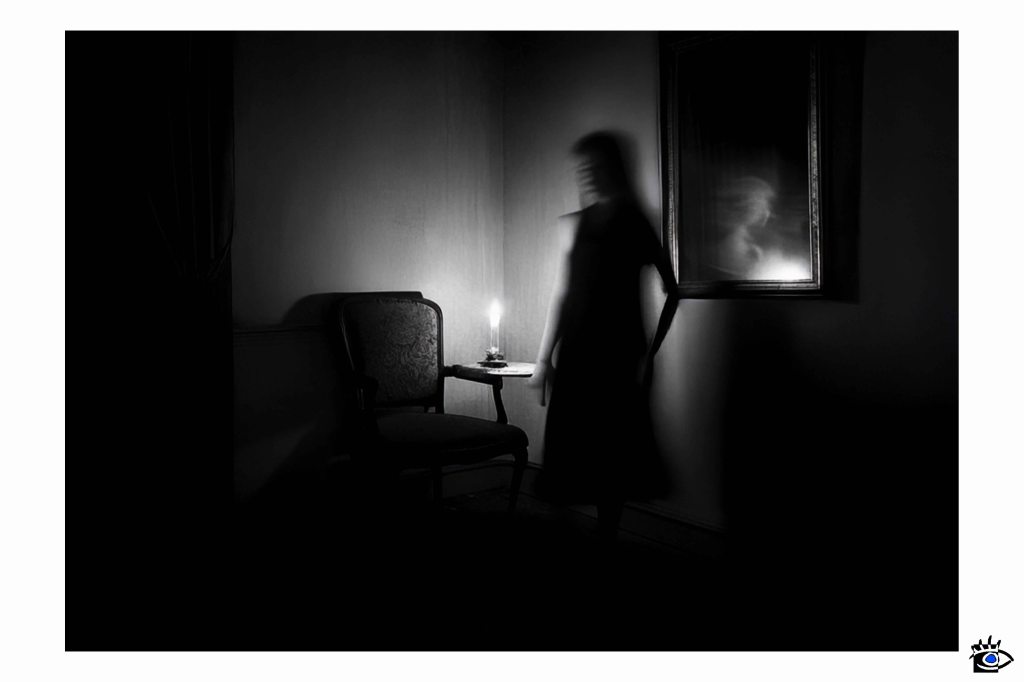 Eerie shadow, spectral reflection by candlelight.