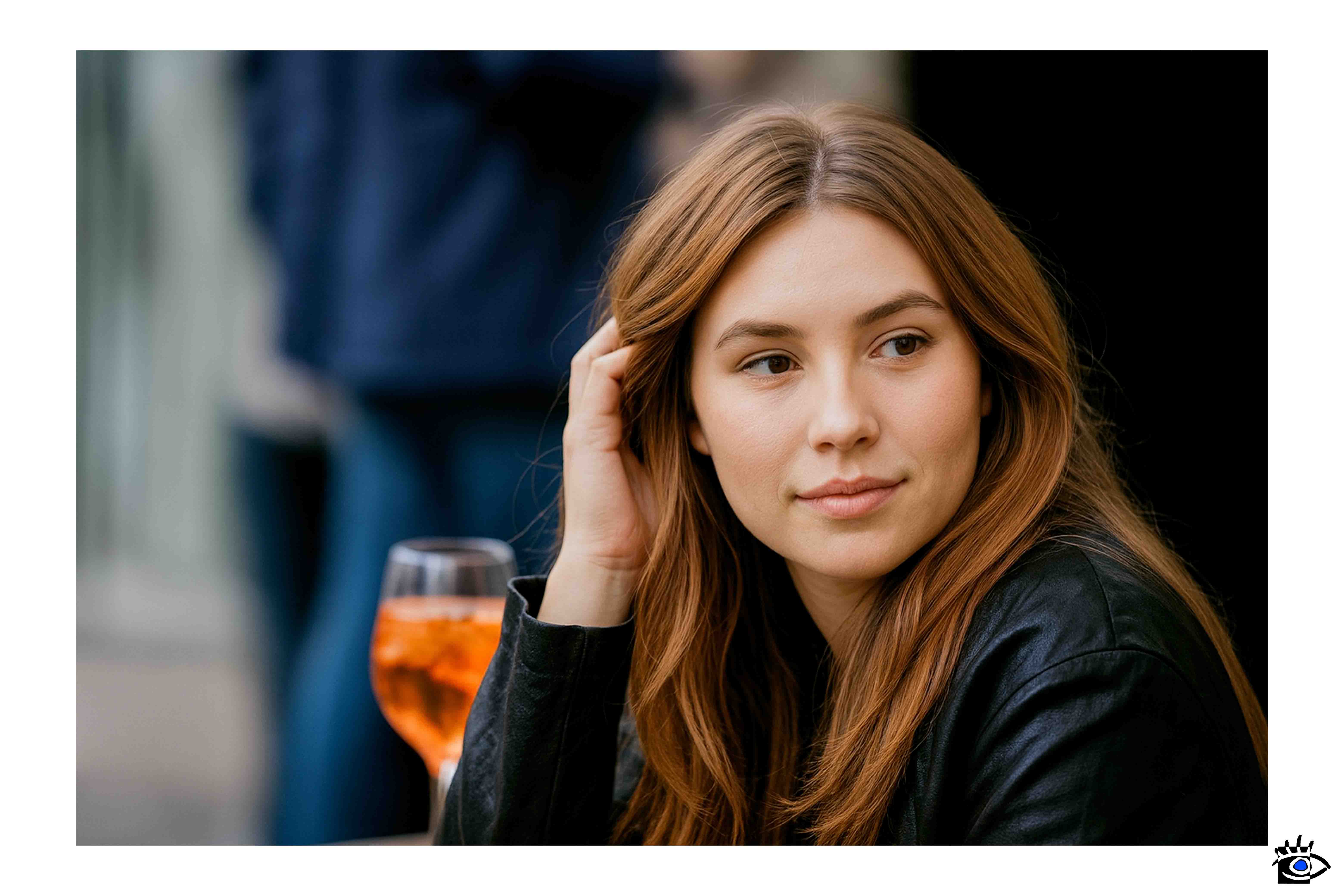 Una giovane donna si concede una pausa tranquilla seduta all’esterno, con un drink accanto.